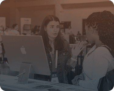 Speaker engaging with attendees at an IIEX event