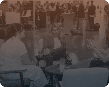 Speaker engaging with attendees at an IIEX event