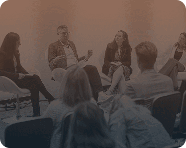 Speaker engaging with attendees at an IIEX event