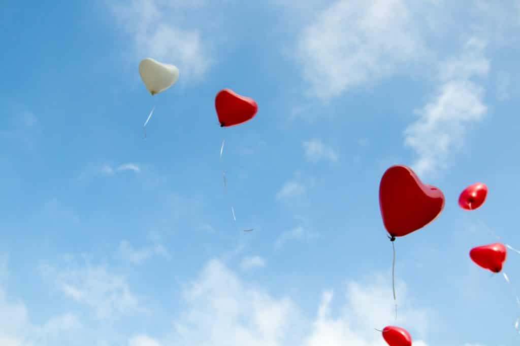 heart shaped balloons floating in the sky
